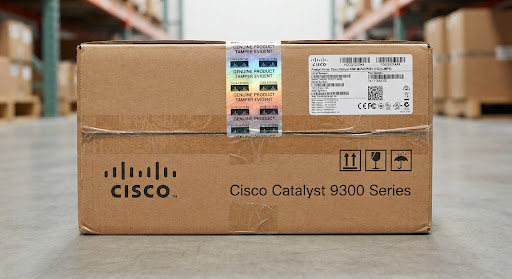 Official Cisco brown cardboard factory shipping carton with authentic holographic tamper-evident security seal and barcode serial labels